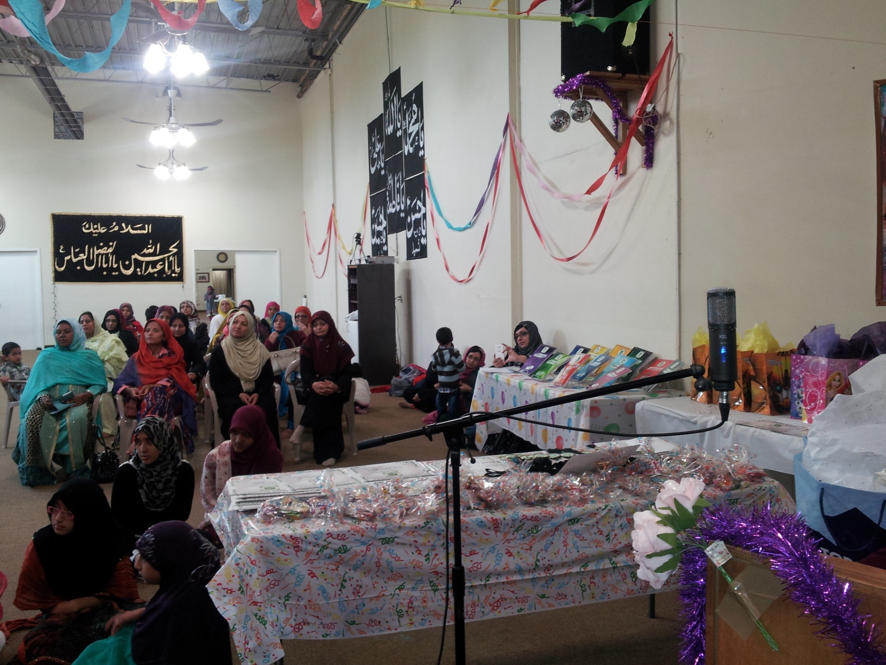 Families seated near the decorated presentation and gift tables